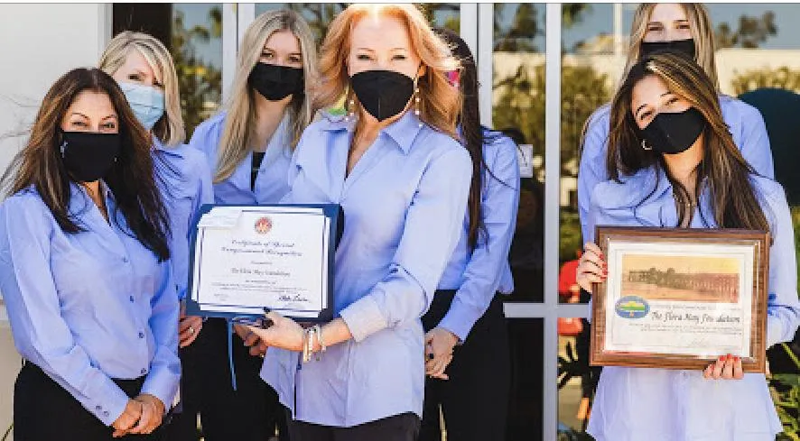 Working Women Winning program participants holding a Flora May Foundation certificate